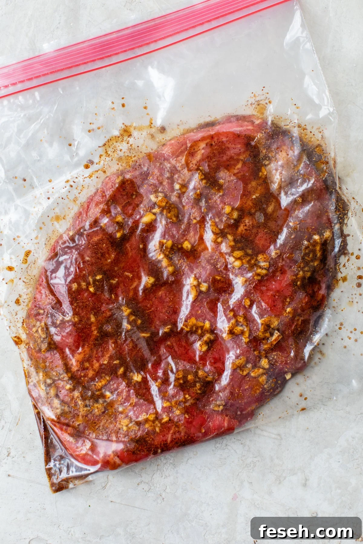 steak marinating in a plastic bag