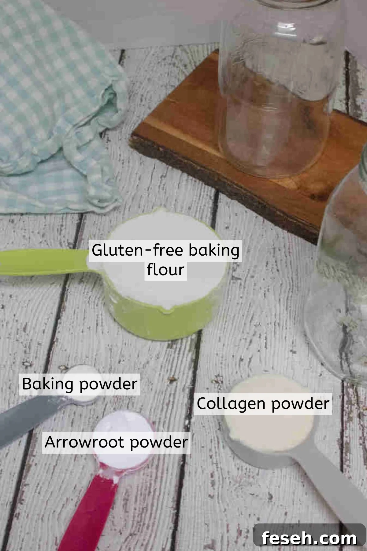 Baking powder, baking flour, collagen powder, and arrowroot powder in measuring cups and spoons.