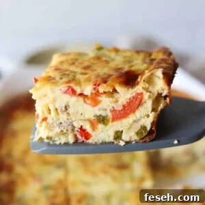 A slice of cottage cheese egg bake being held up in front of the camera by a spatula.