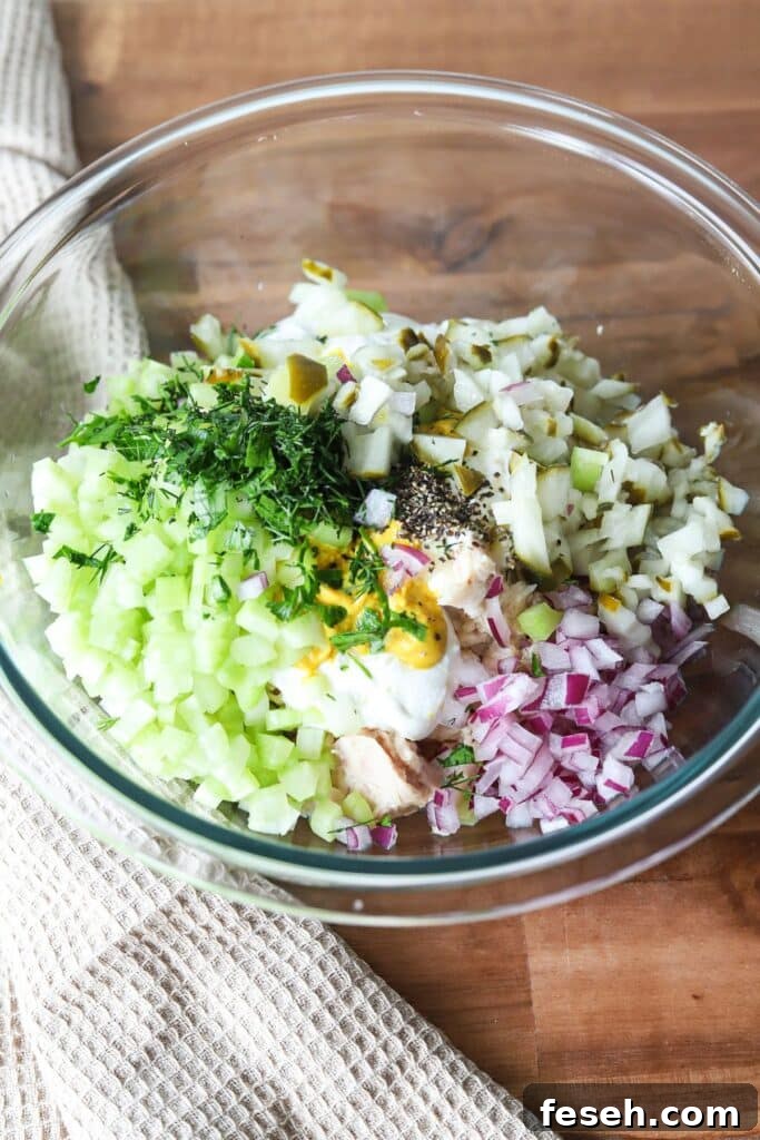 Cottage cheese tuna salad ingredients in a glass bowl.