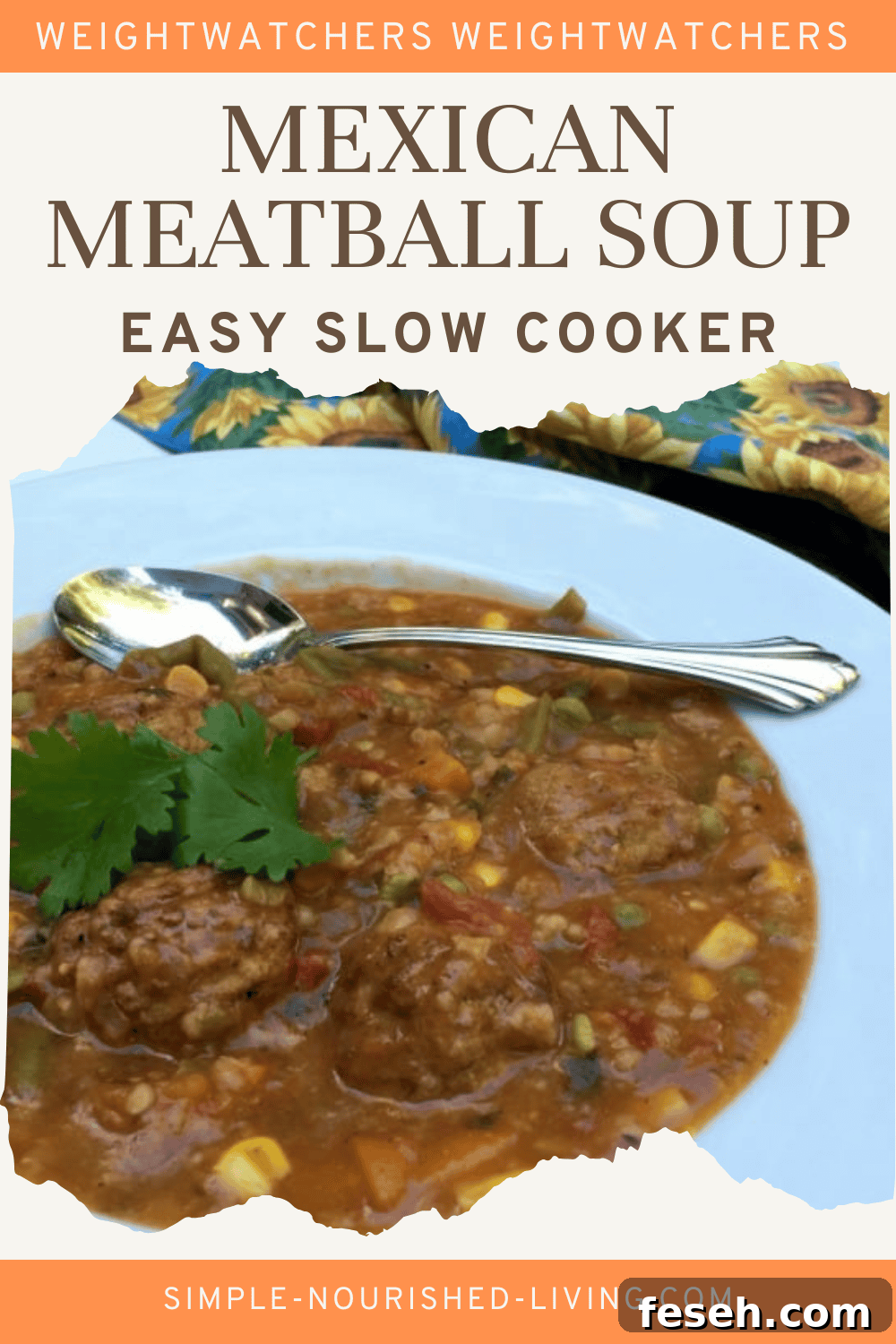 Mexican Meatball Soup topped with fresh cilantro in a white bowl with spoon.