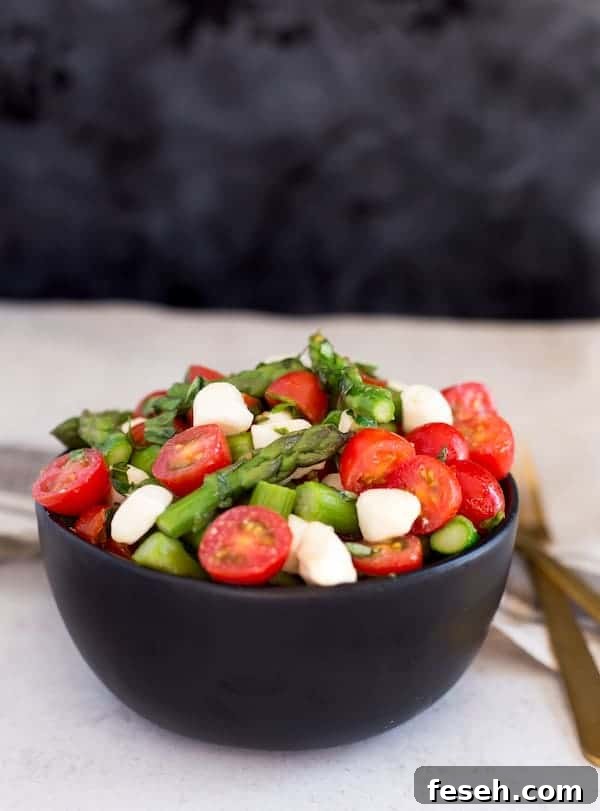 Asparagus Caprese Salad Beautiful Shot with a Dark Background and a Light Table