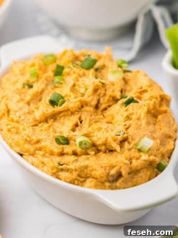 Buffalo chicken dip in an oval baking dish.