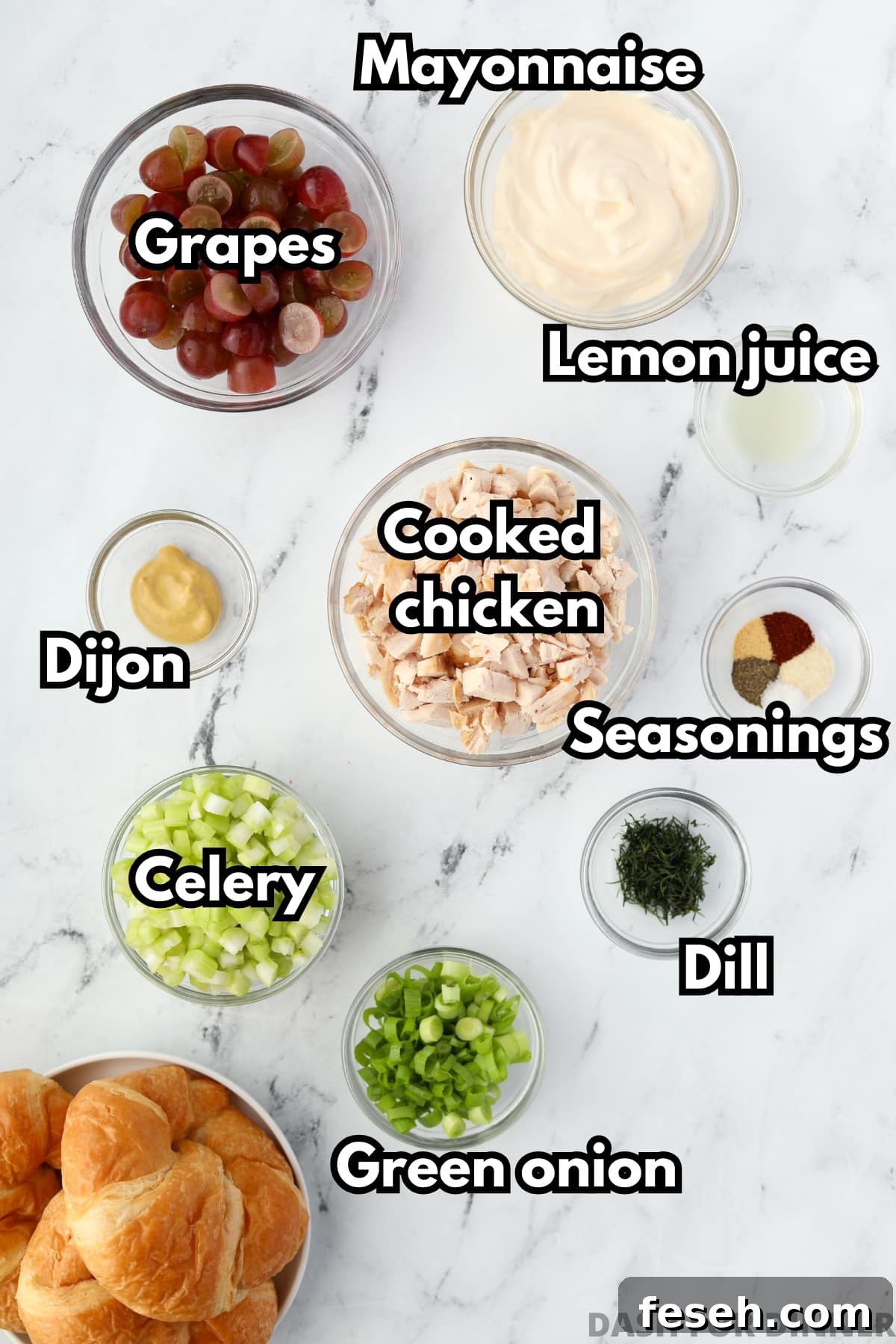 The ingredients needed to make chicken salad, including cooked chicken, celery, green onion, mayonnaise, etc.