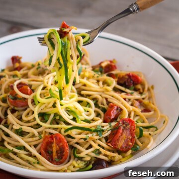 Zucchini noodles with roasted tomatoes in a bowl.