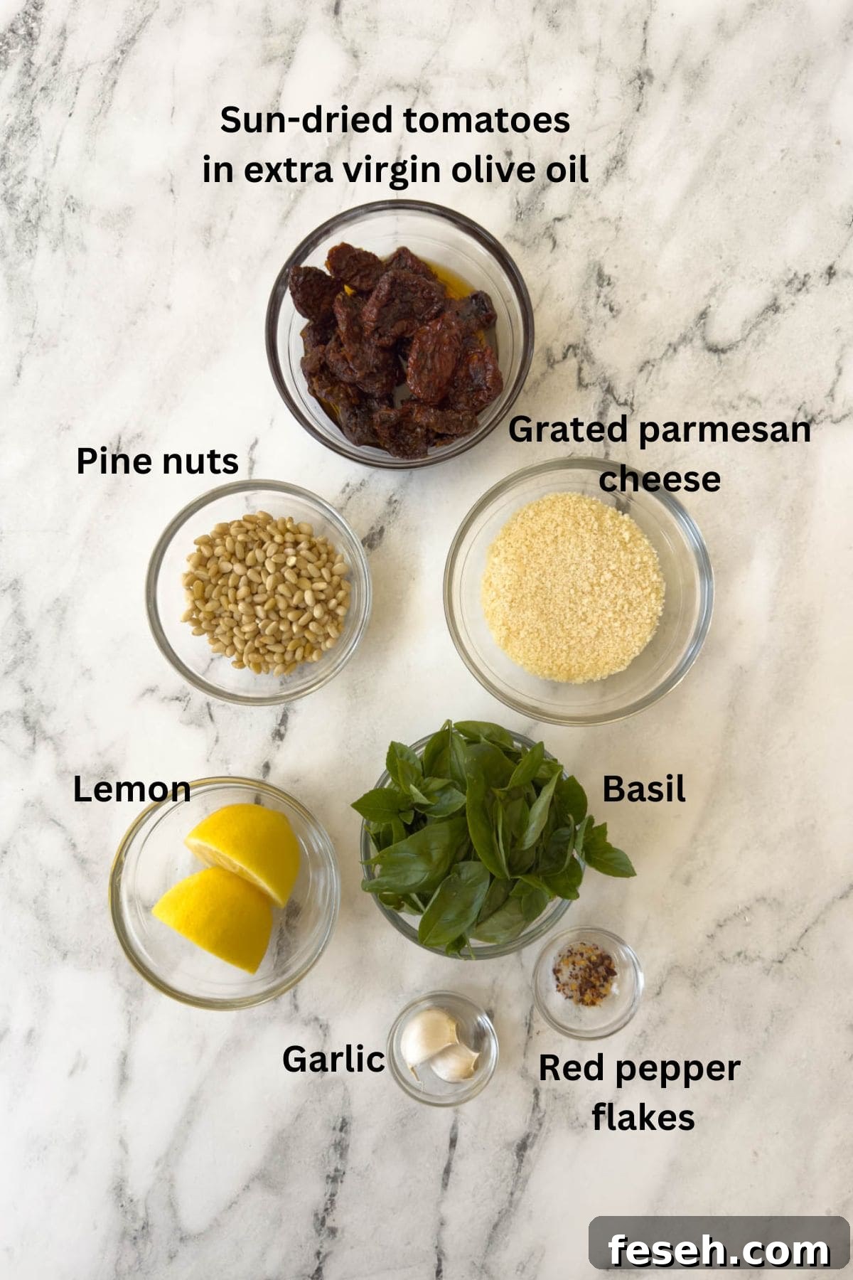 Ingredients for pesto rosso or sun-dried tomato pesto on the counter.