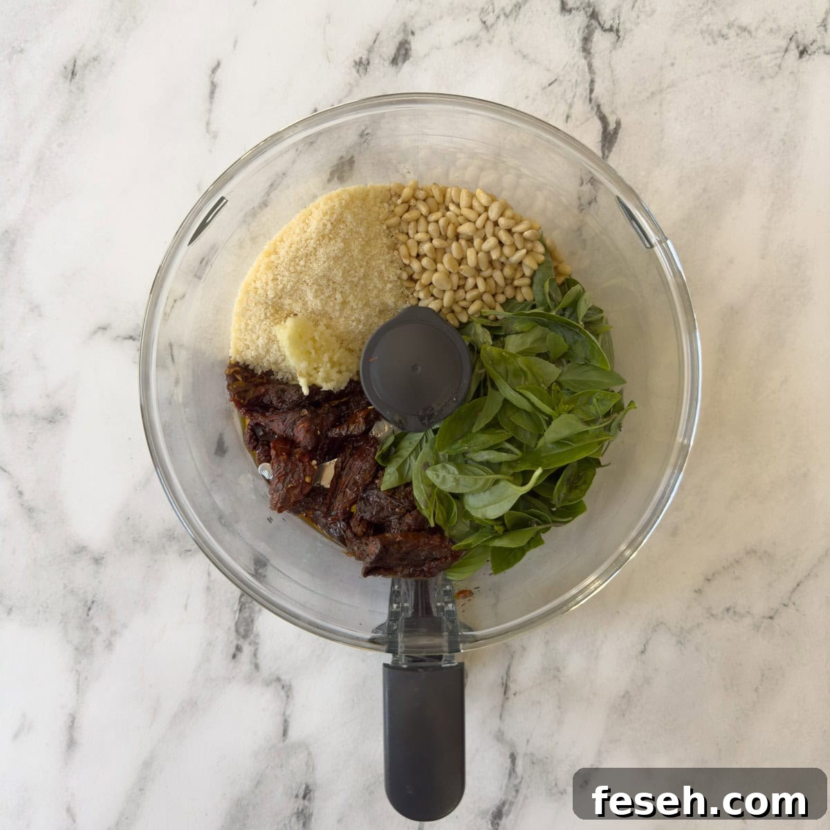 Sun-dried tomato pesto ingredients in a food processor.