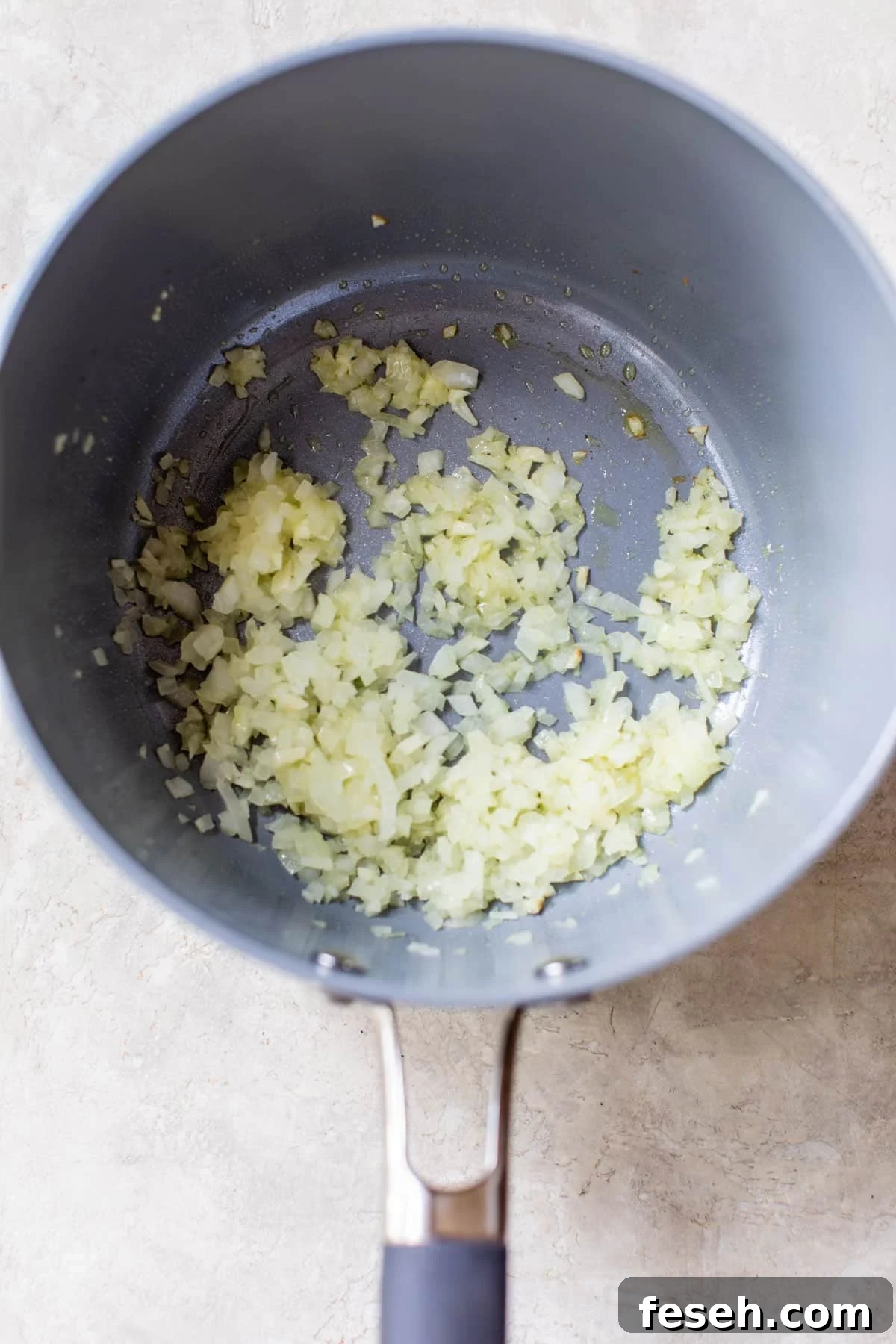 cooked diced onion in a saucepan