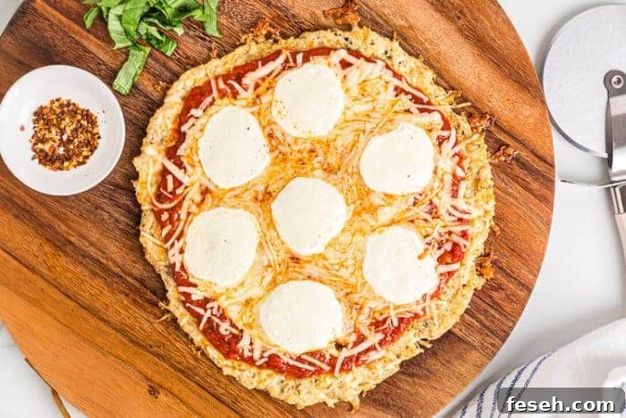 overhead view of cooked keto chicken crust pizza with melted cheese