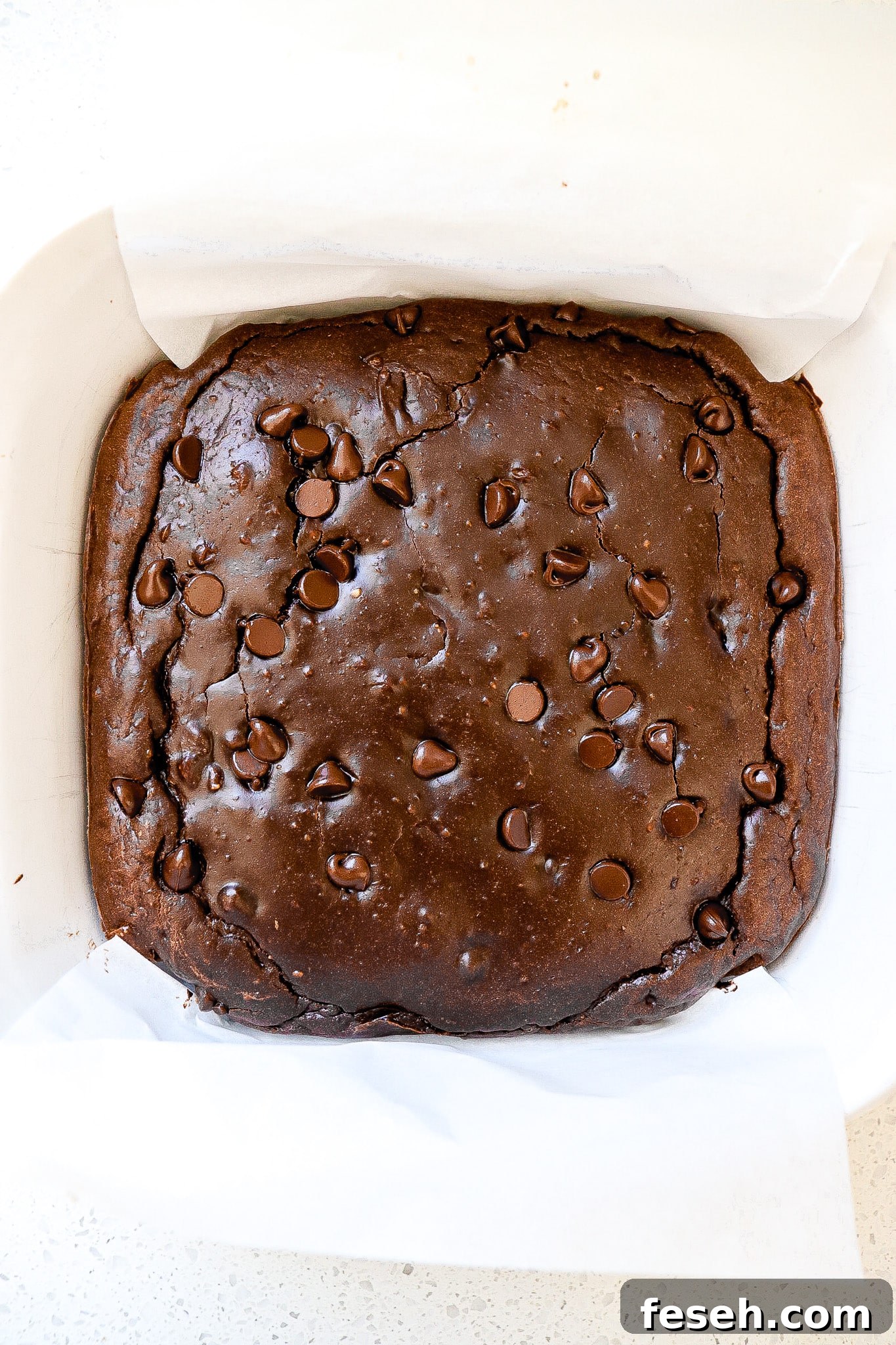 Top down view of fudge protein brownies in baking dish.