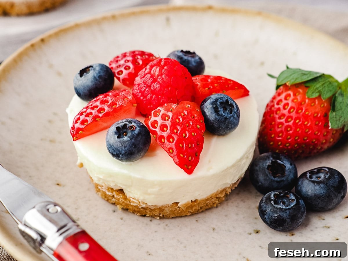 Cheesecake on a plate with fresh berries and a fork.