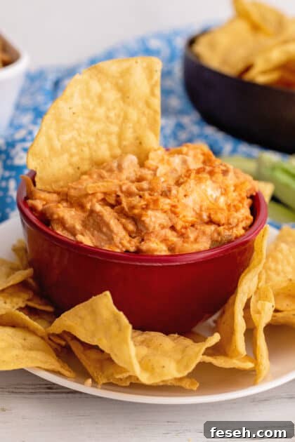 Bowl of buffalo chicken dip with tortilla chips (game day recipes).