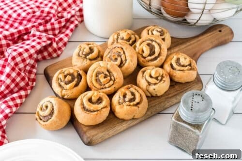 Sausage pinwheels on wooden board.