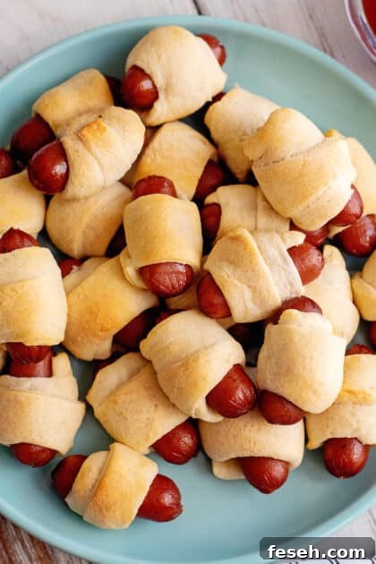 A plate filled with little smokies pigs in a blanket.
