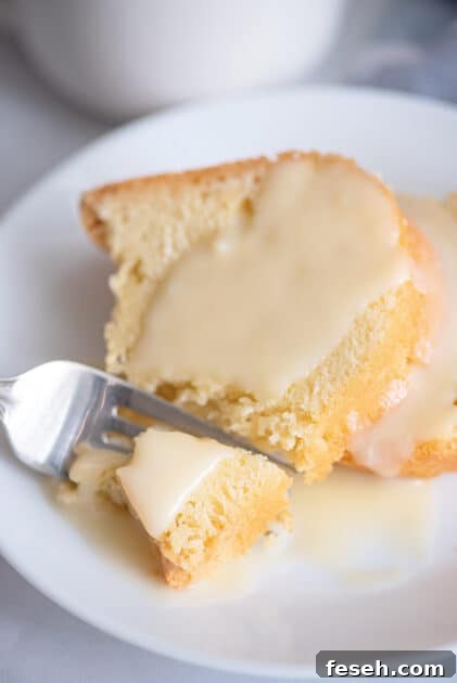 Fork breaking off piece of pound cake.
