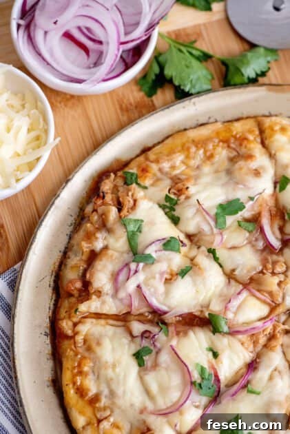Slicing barbecue chicken pizza.