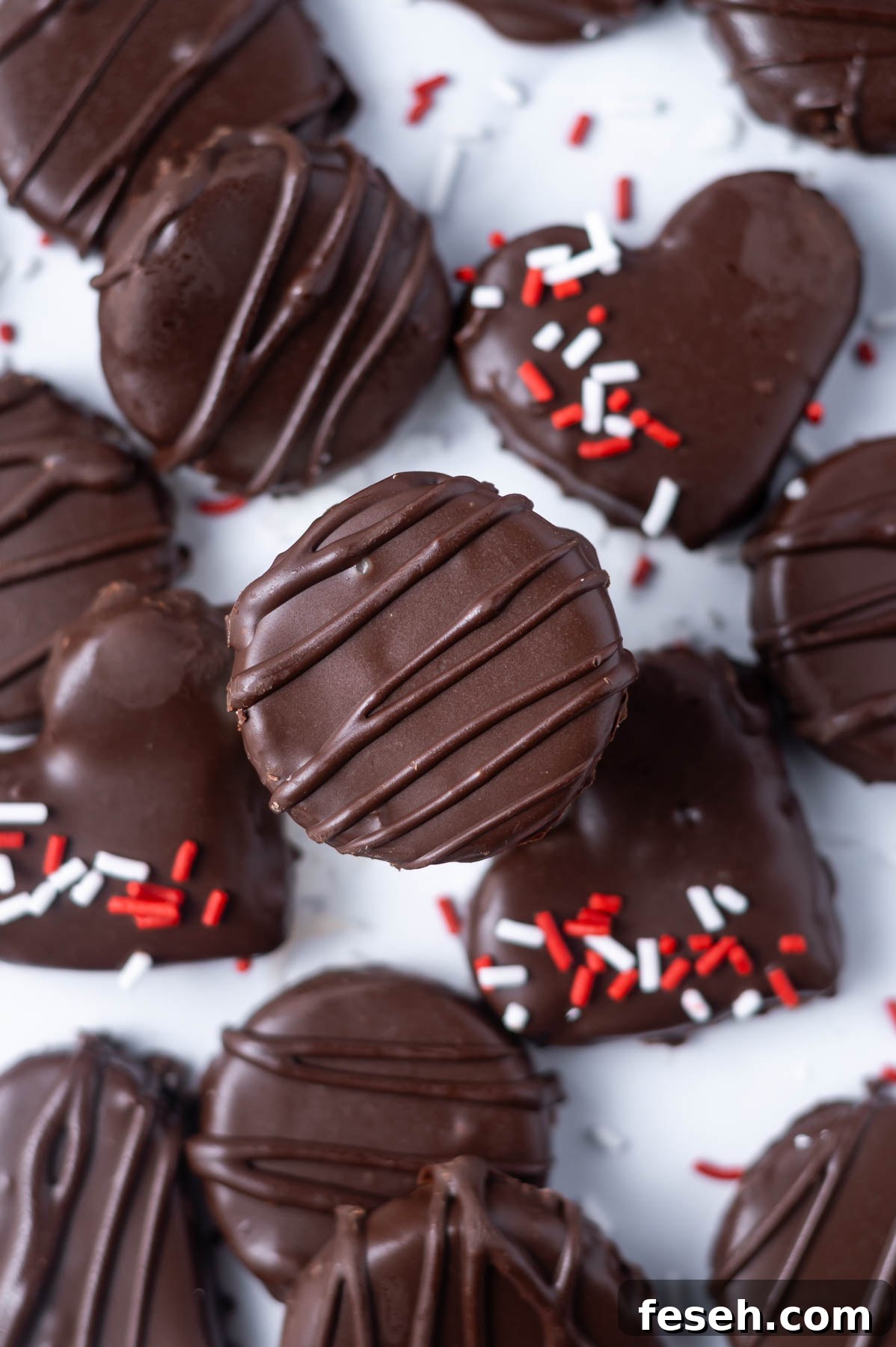 chocolate candies, some in heart shapes with red and white sprinkles