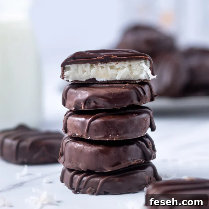 stack of chocolate candies with the top cut to show the coconut middle