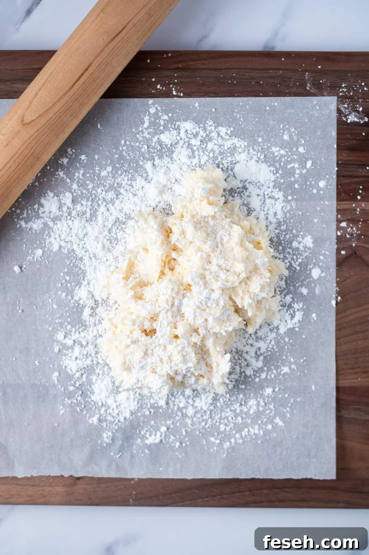 coconut mixture on a confectioners' sugar coated piece of parchment paper