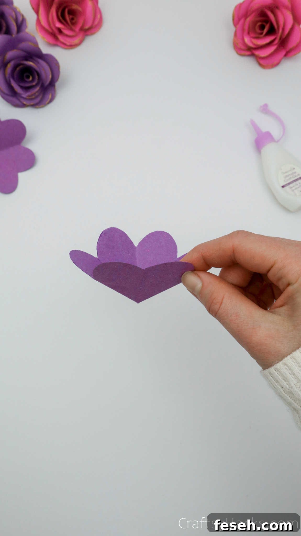 holding paper flower