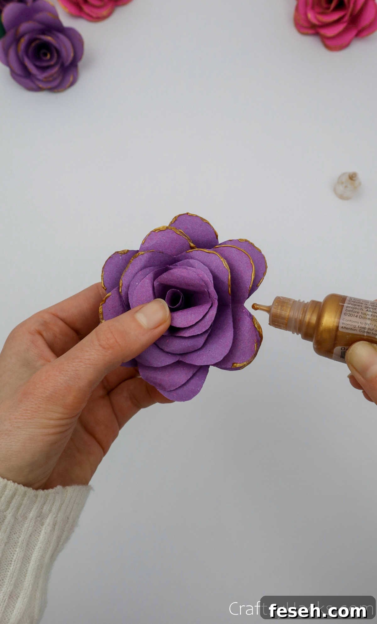 adding gold paint to flower