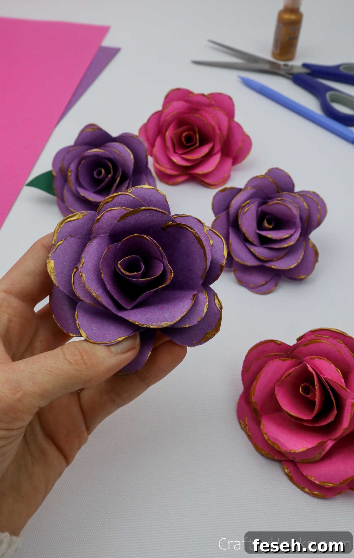 holding paper flower