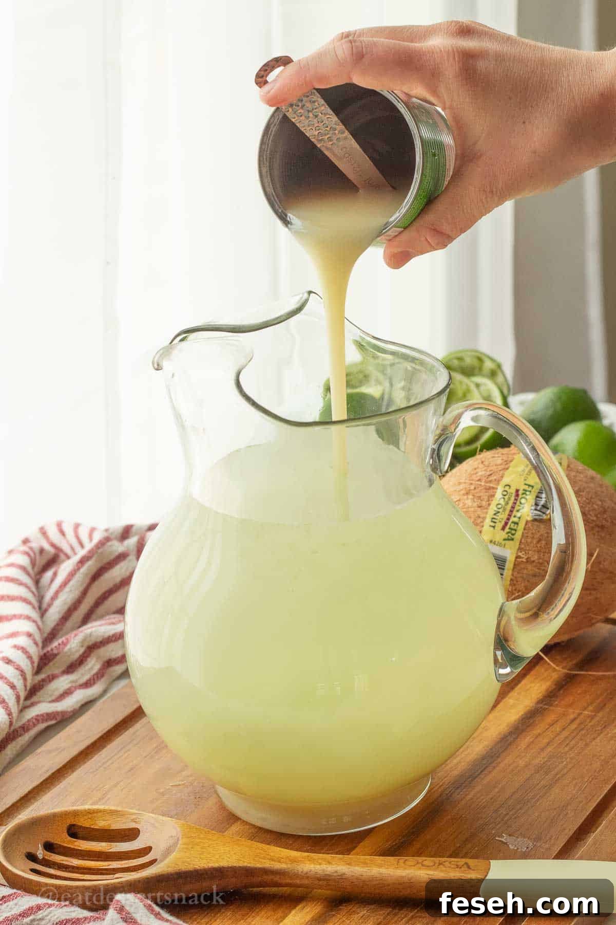 Pouring coconut condensed milk into pitcher.