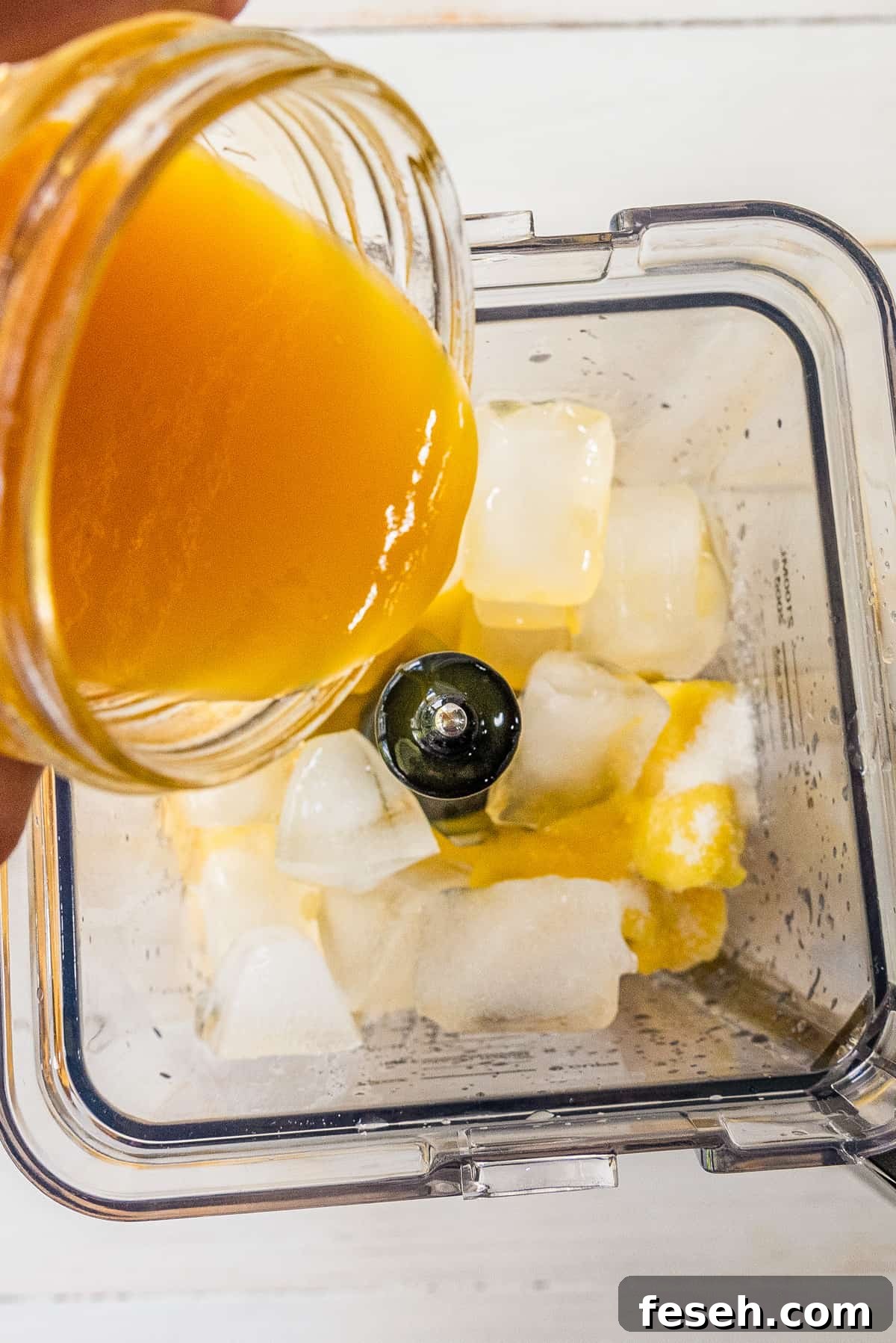 adding ingredients to a blender to make the recipe
