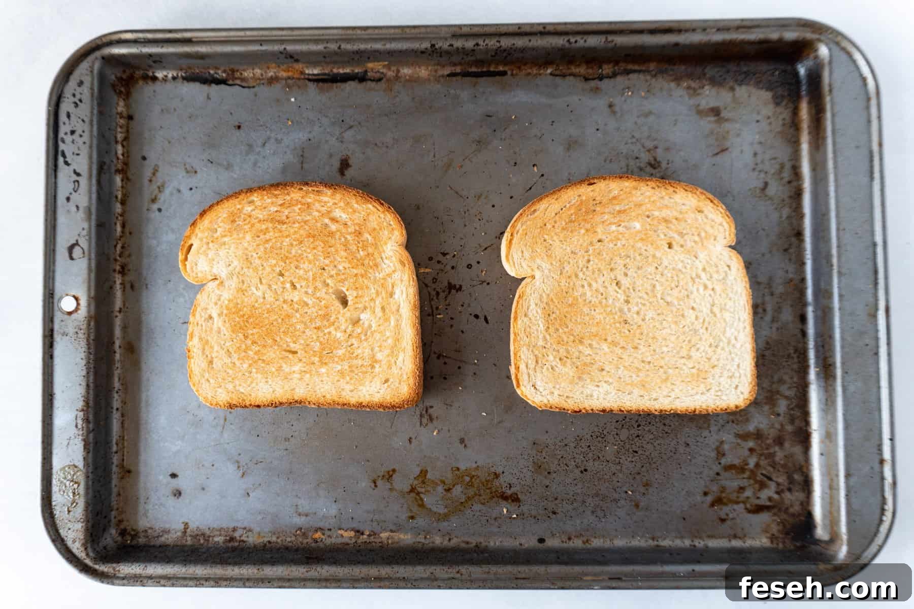 toasted white bread on baking sheet.