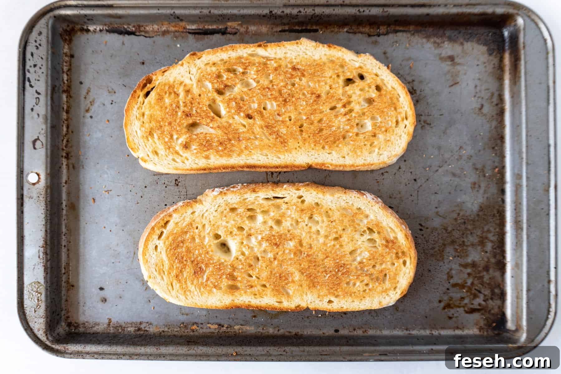 toasted sourdough on baking sheet.