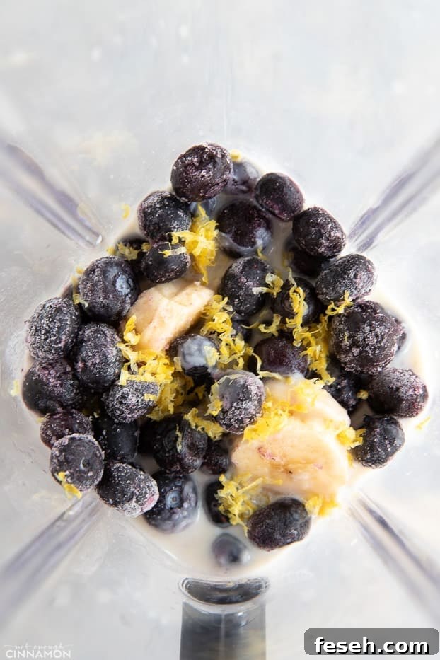 Frozen blueberries, banana and lemon zest in a blender