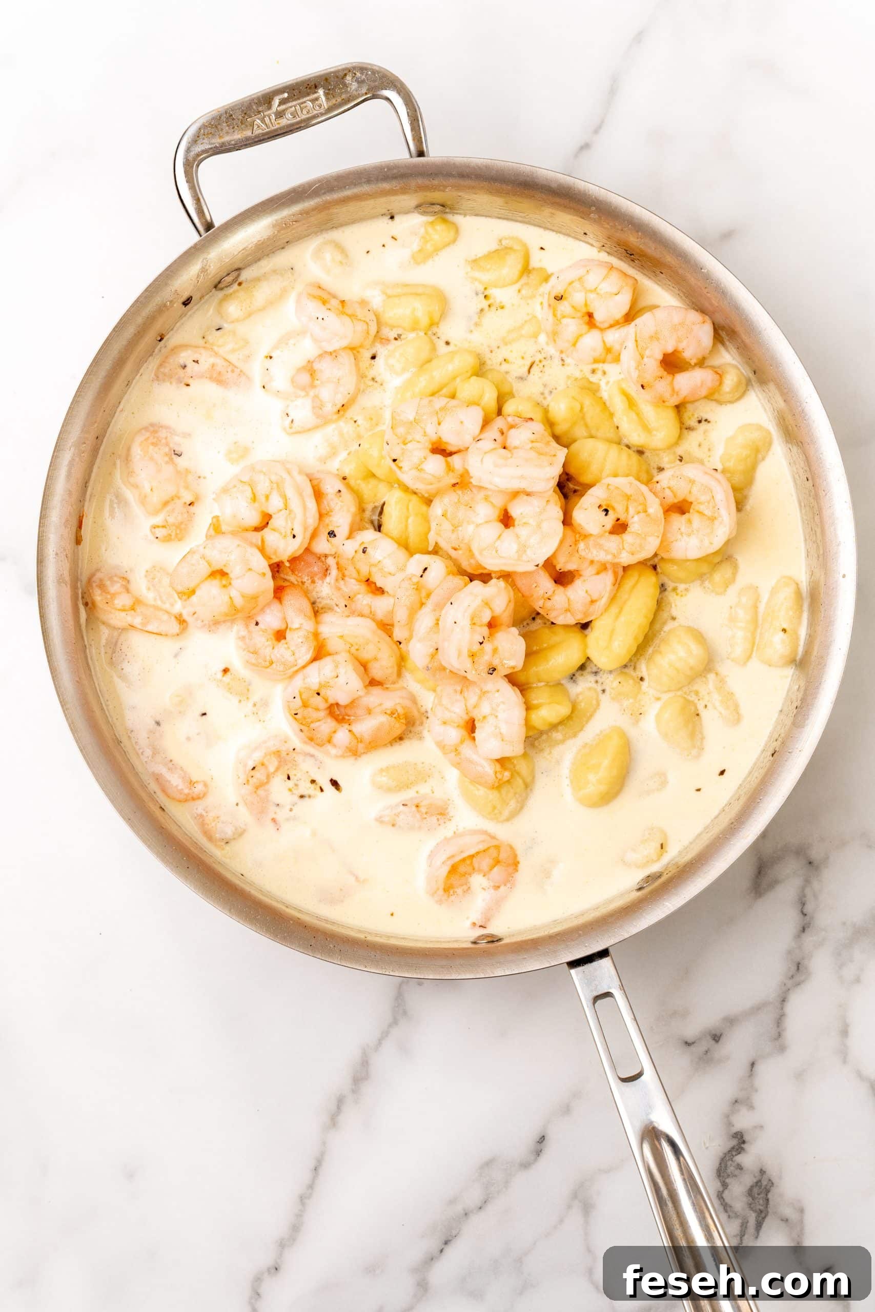 creamy shrimp scampi gnocchi in a large silver skillet