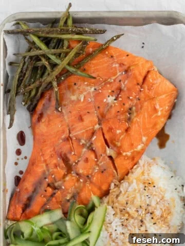 Teriyaki Salmon on a sheet pan with rice and vegetables.