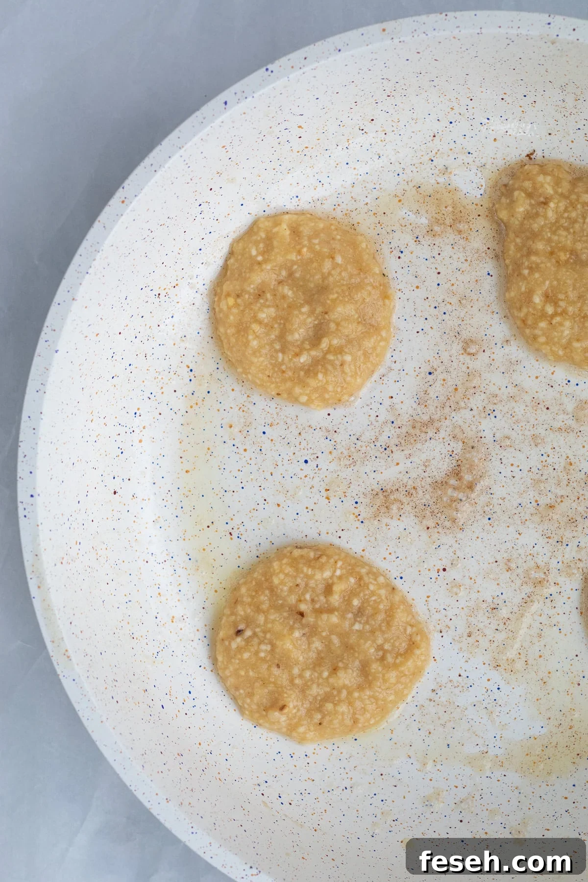 matzo meal pancake batter in a butter frying pan