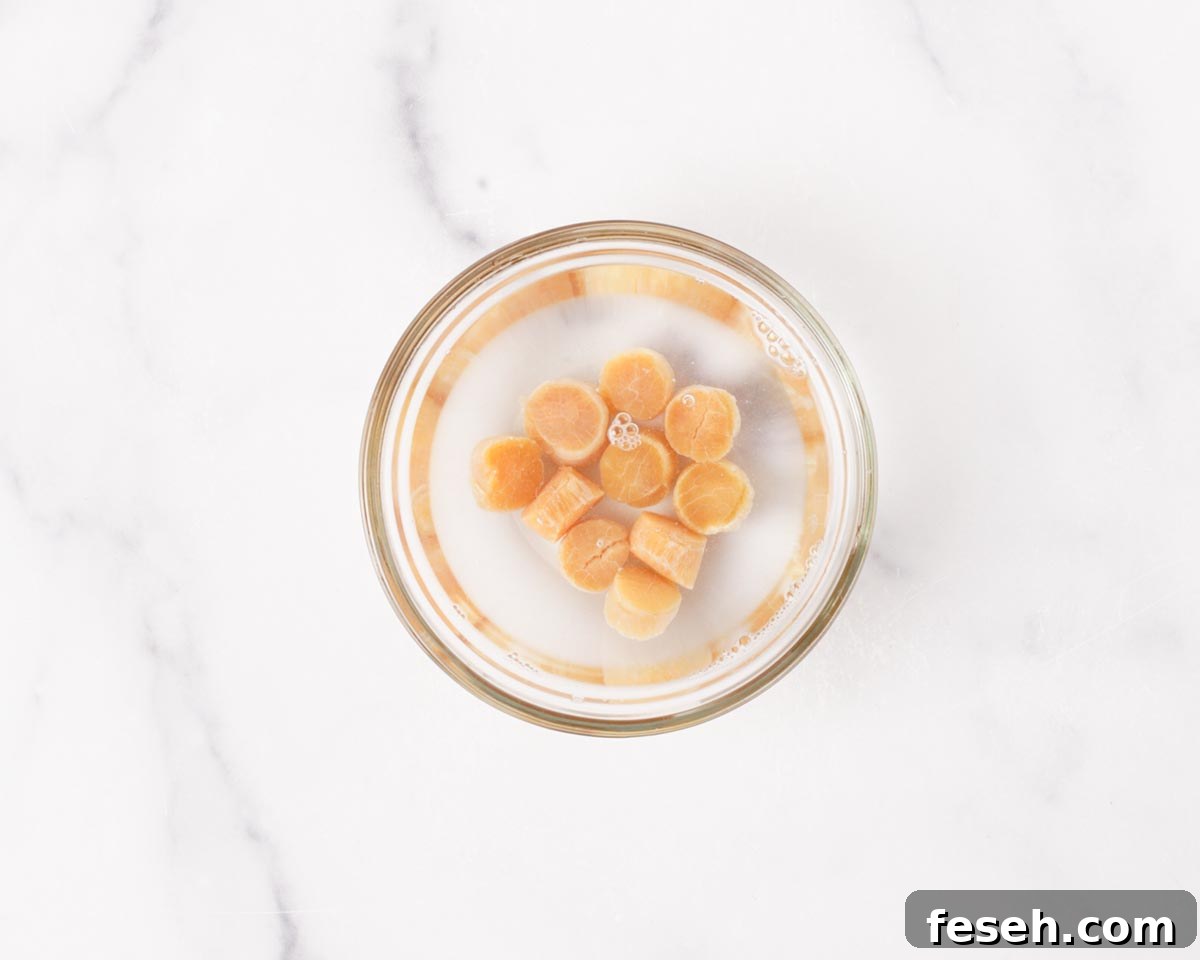 Soaking dry bay scallops.