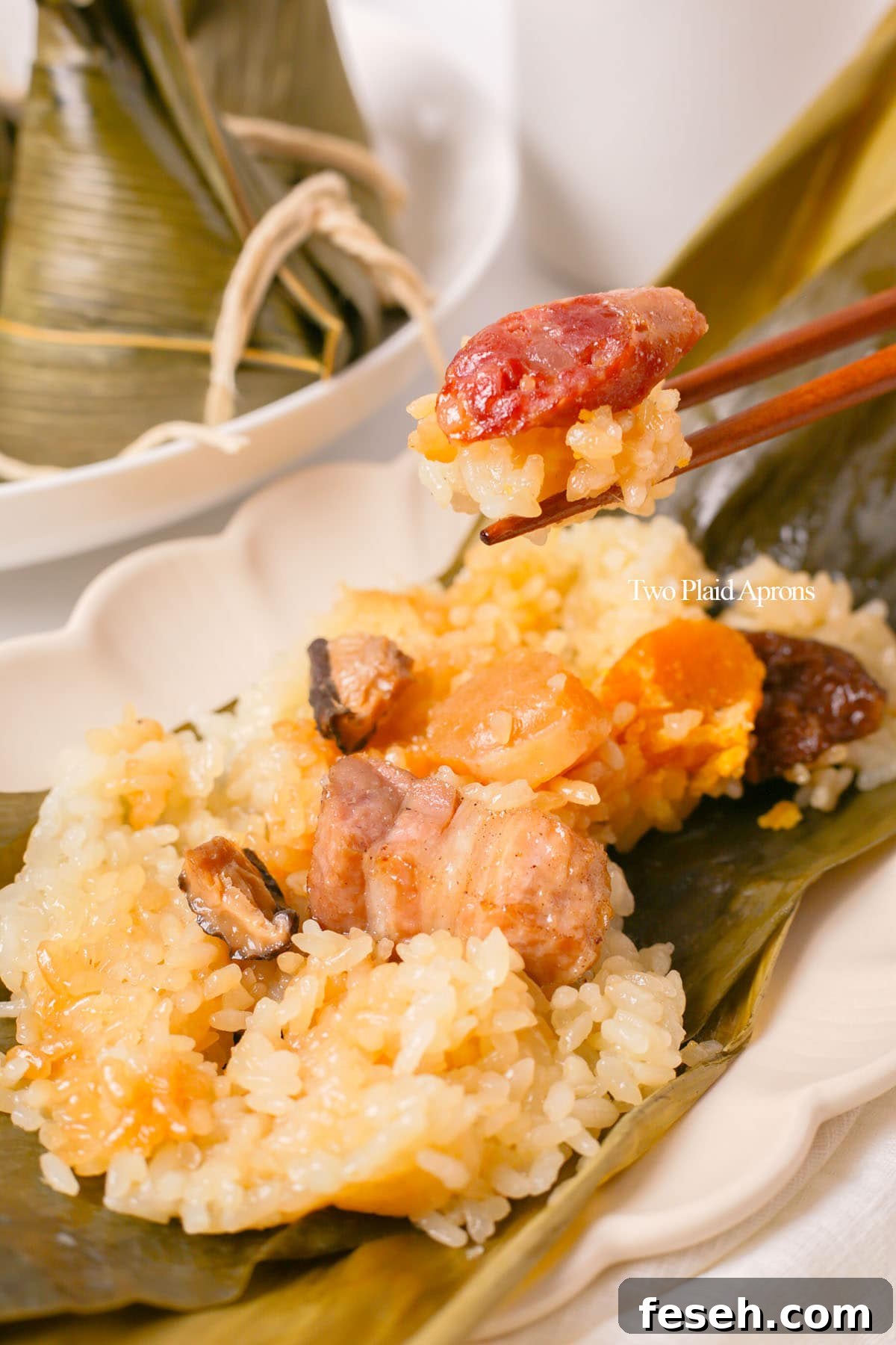Picking up zongzi with chopsticks.