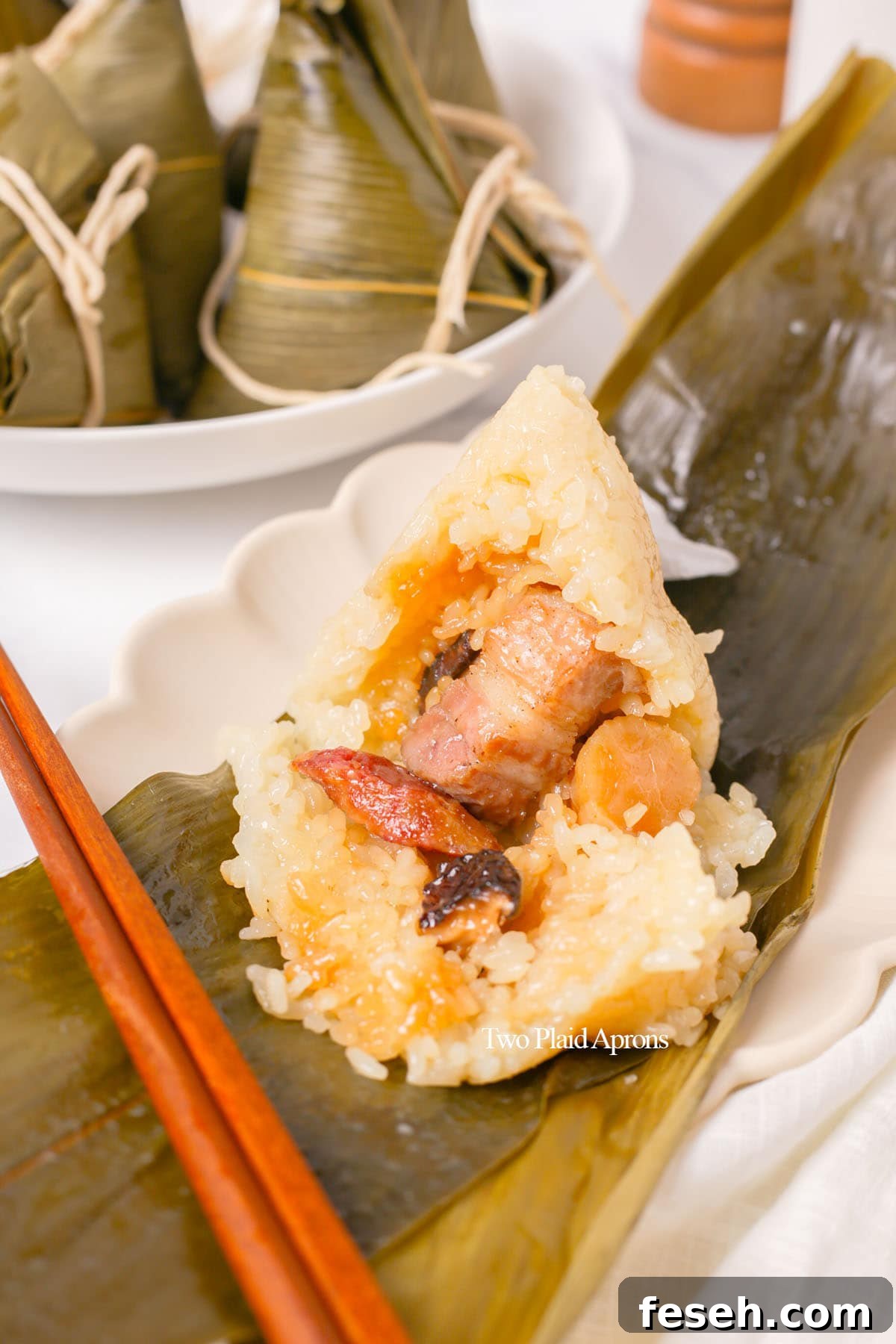 Zongzi with rice opened to show filling.