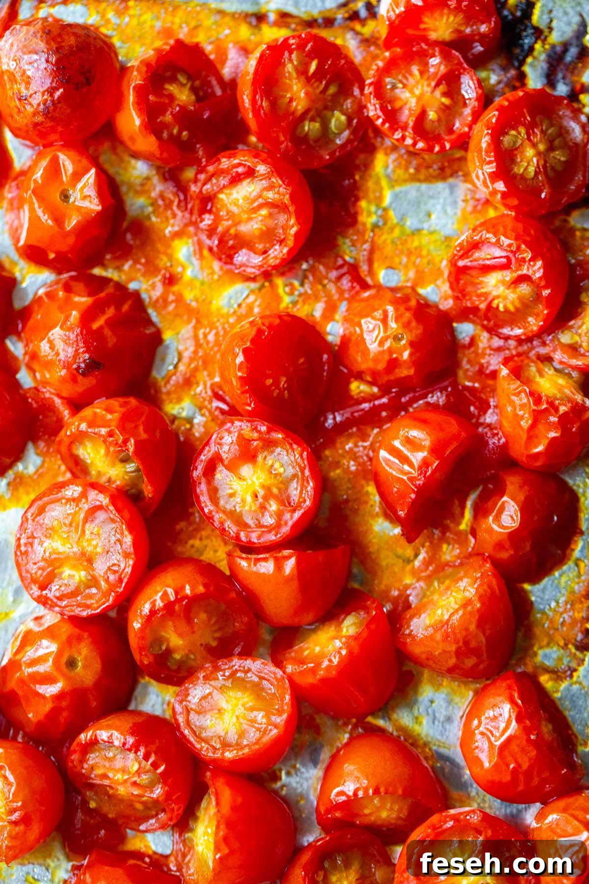 Roasted cherry tomatoes on a baking sheet.