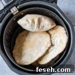 cooked flatbread inside the air fryer basket