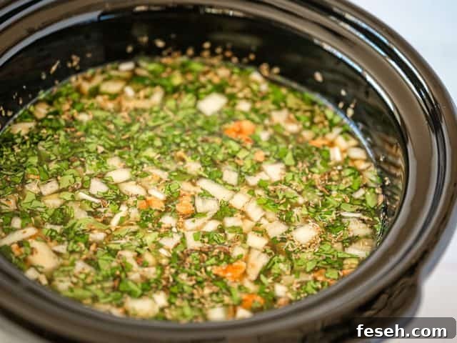 slow cooker with lentil soup ready to cook