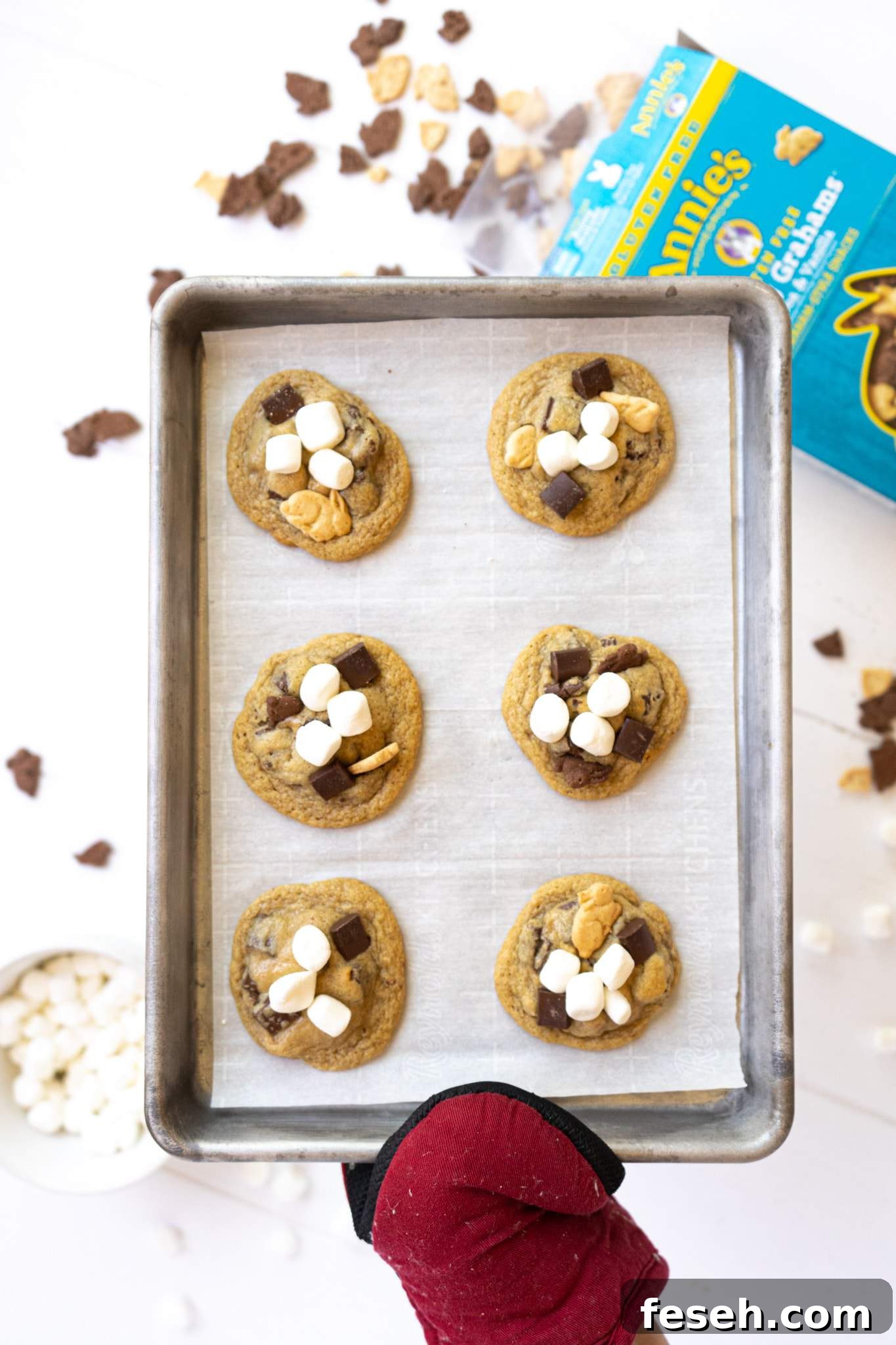 A hand holding a tray full of gluten free s'mores cookies.