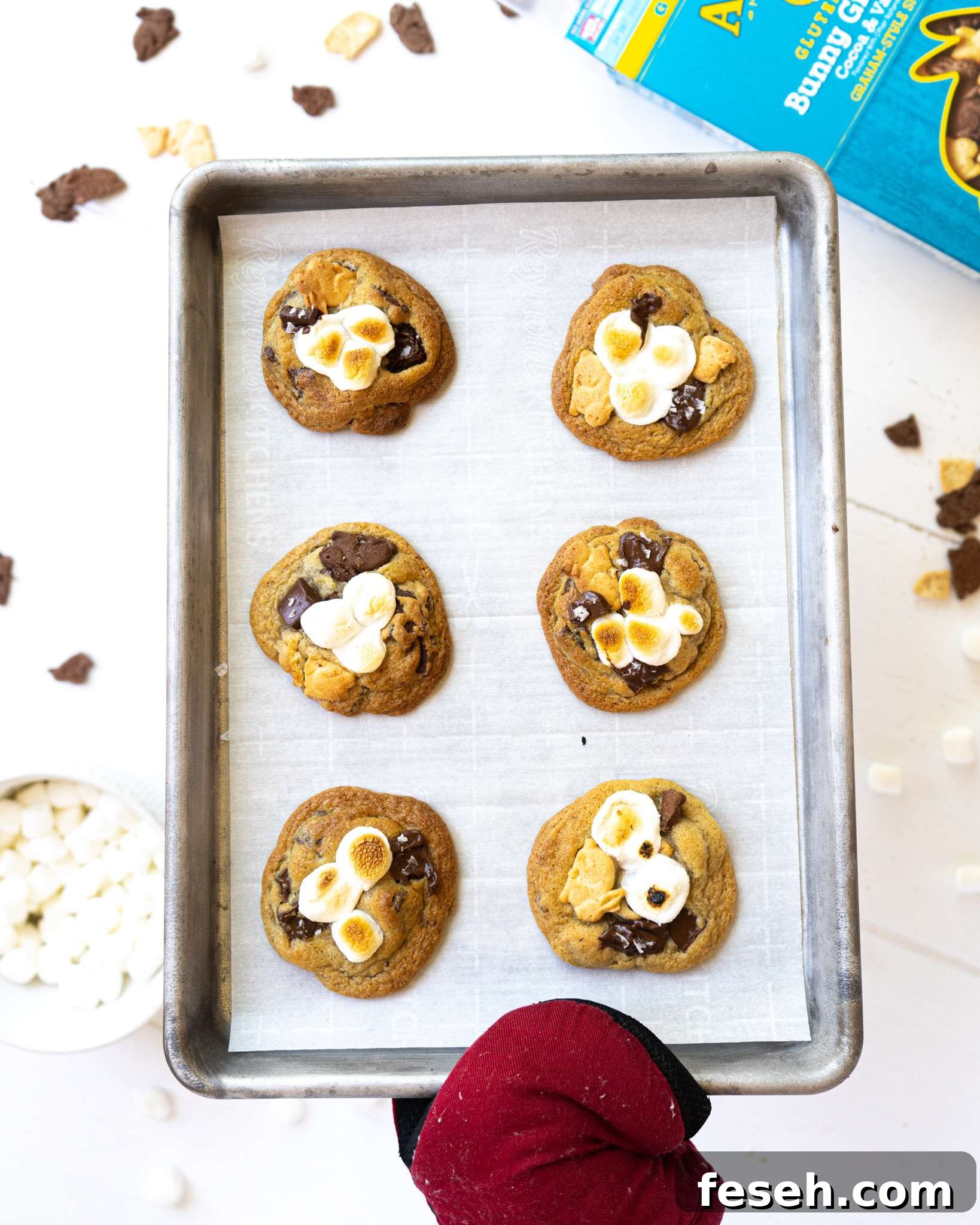 A hand holding a tray full of gluten free s'mores cookies.