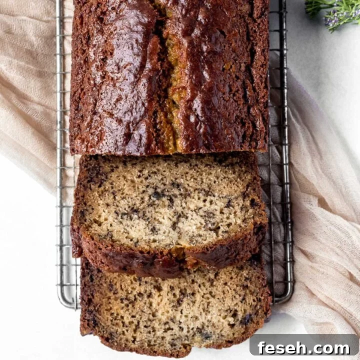 Sour cream banana bread sliced and served on a cooling rack.