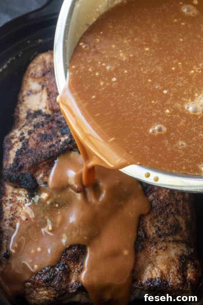 hawaiian sauce being poured over slow cooker pork