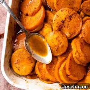 Baking dish with candied sweet potato and a spoon.