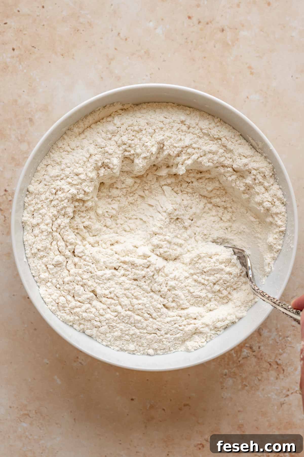 Flour and baking powder mixed in a bowl.