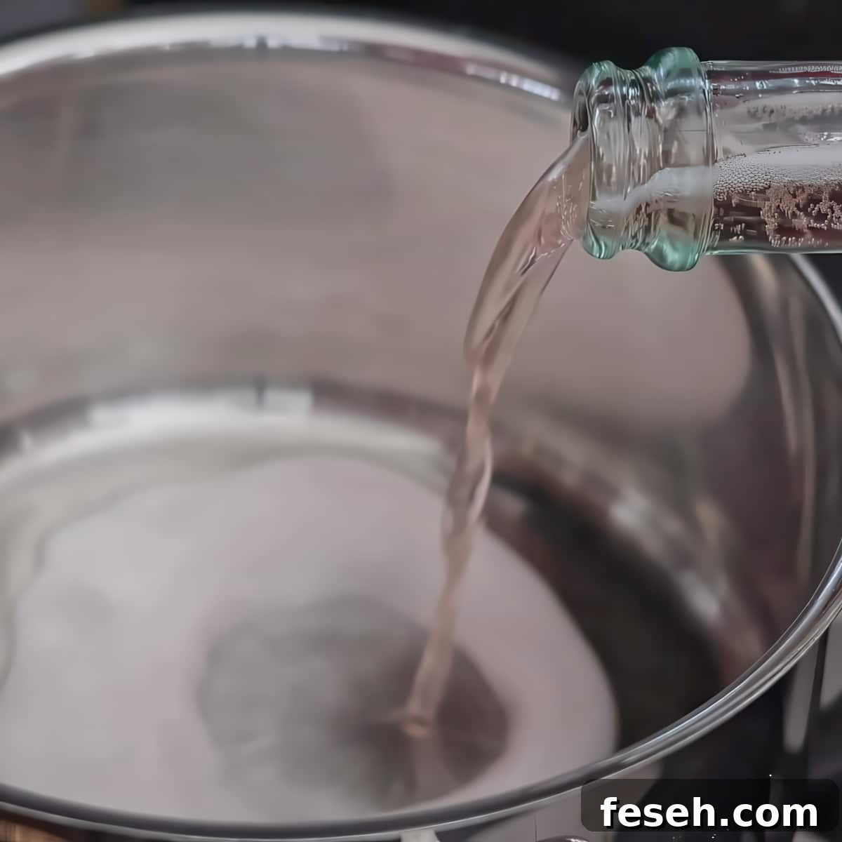 pouring pink champagne into small saucepan.