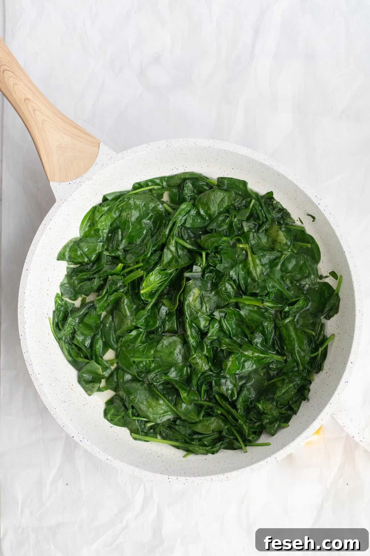 10-Minute Spinach Purée for Babies: Smooth, Nutritious Baby Food 4 wilted spinach in a pan