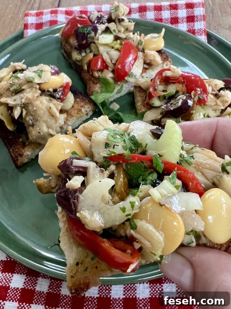 Insalata di baccala on pieces of toasted bread, bruschetta salad.