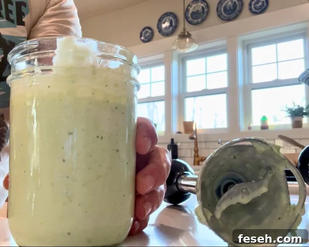 tomatillo jalapeno ranch dressing in mason jar with emersion blender next to it